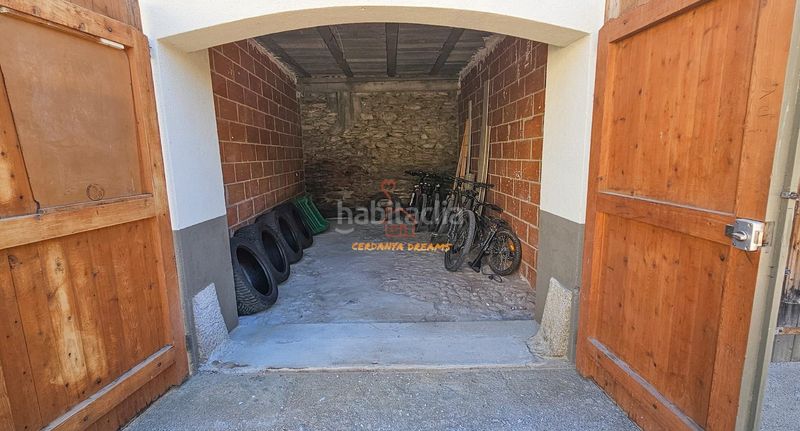 Foto 0bf7b85c-de45-456f-b3bd-7ea53ddaa006. Planta baixa amb xemeneia calefacció aparcament a Osseja
