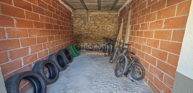 Foto fcc40901-7a0a-4505-a33a-3eacbdad0bba. Planta baixa amb xemeneia calefacció aparcament a Osseja
