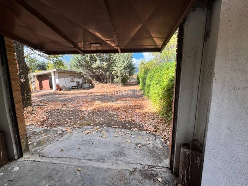 Foto c53f9d52-3251-43a6-8d53-f7b43c0e12db. Casa  unifamiliar con garaje y jardín en Villavieja del Lozoya