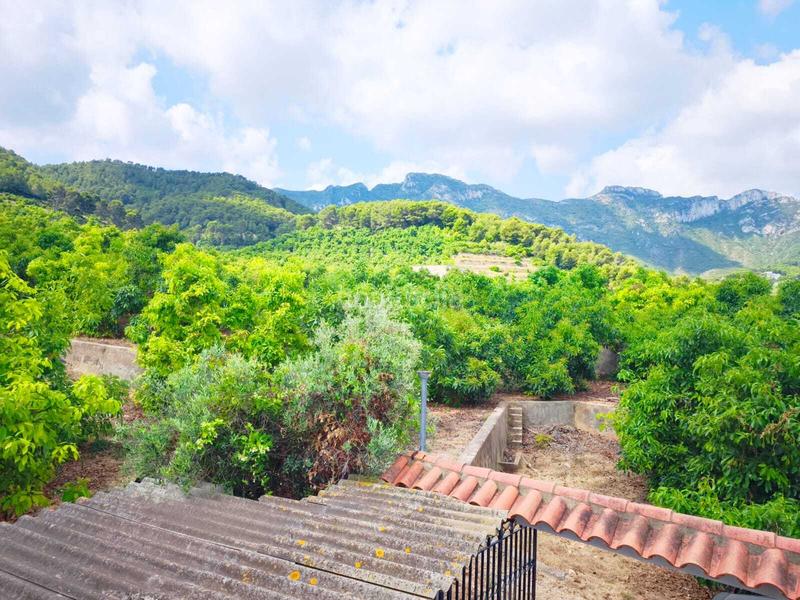 Foto 6de2624f-045a-41cc-923e-9459af2d4219. Casa adossada amb aparcament a Llaurí