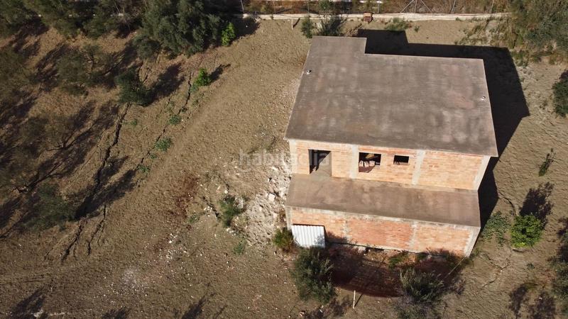 Foto 0f366b0c-4300-4604-ba50-aa7ca1d429bf. Finca rústica terreno rústico de 3.750 metros, con casa de apero, olivares y edificación sin terminar. en Coín