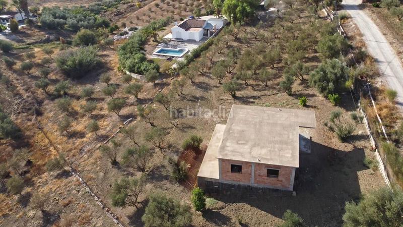 Foto 2b2bff9c-002f-44b6-ab05-087b2bb56873. Finca rústica terreno rústico de 3.750 metros, con casa de apero, olivares y edificación sin terminar. en Coín