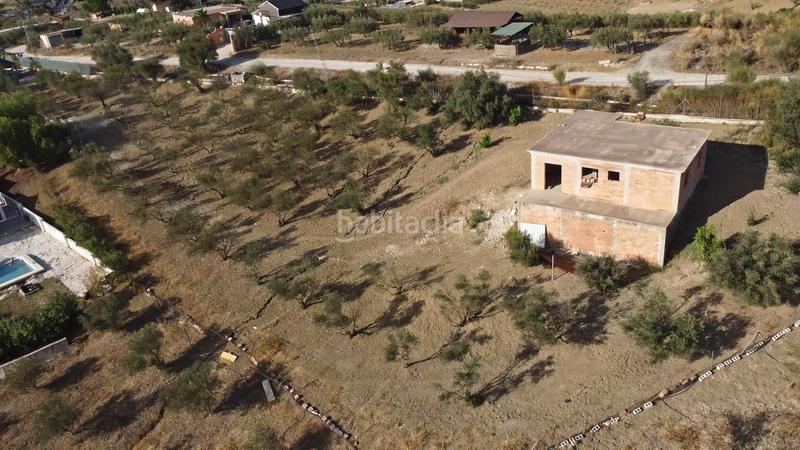 Foto 314198bf-0f7d-4baa-b5cd-41cdb49173e1. Finca rústica terreno rústico de 3.750 metros, con casa de apero, olivares y edificación sin terminar. en Coín