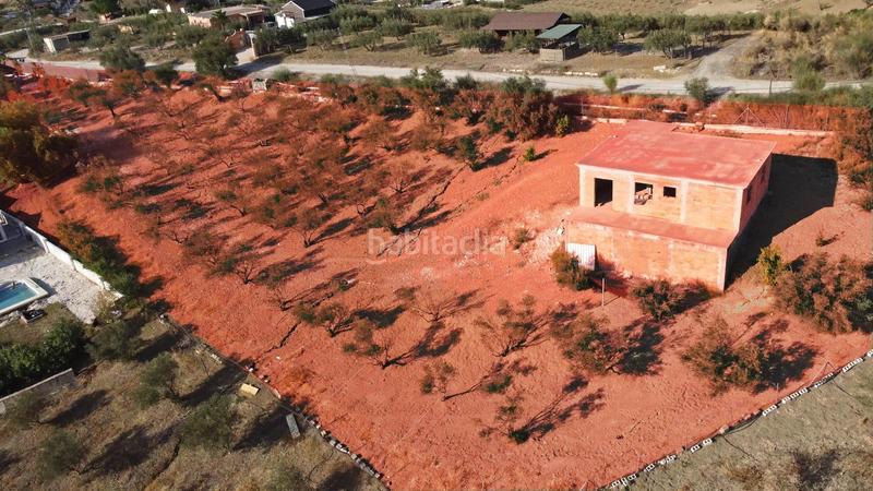Foto 7a96db92-9c2d-4df8-bb33-f49f791c059d. Finca rústica terreno rústico de 3.750 metros, con casa de apero, olivares y edificación sin terminar. en Coín