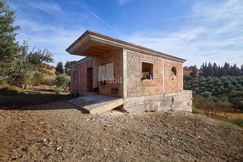 Foto a1ba9b1a-2f74-4660-bfde-26986255da1d. Finca rústica terreno rústico de 3.750 metros, con casa de apero, olivares y edificación sin terminar. en Coín