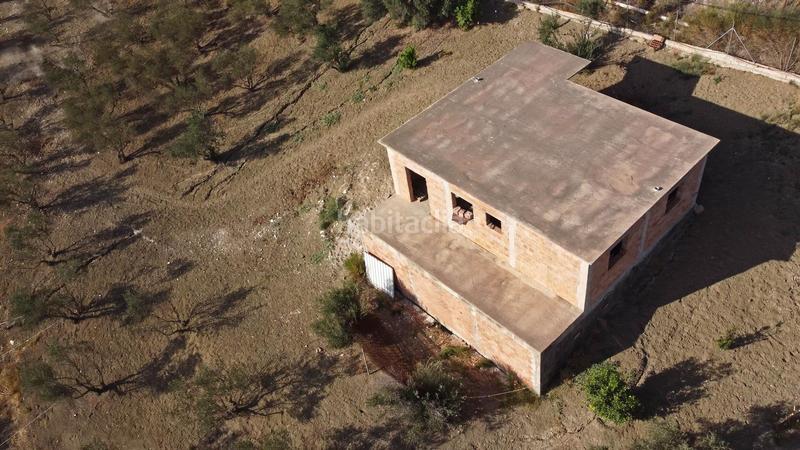 Foto bf4d3140-1555-4d16-bd16-3094dbe0d359. Finca rústica terreno rústico de 3.750 metros, con casa de apero, olivares y edificación sin terminar. en Coín