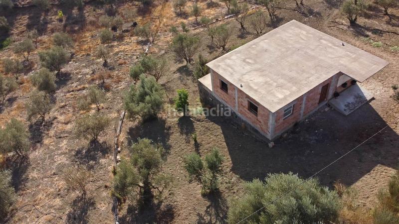 Foto f15932c4-fefd-414e-b392-15934778a60b. Finca rústica terreno rústico de 3.750 metros, con casa de apero, olivares y edificación sin terminar. en Coín
