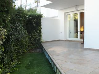 Apartamento  Port joan. Bajo con jardín en residencia con piscina