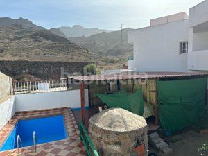 Foto f0b096f3-e3fb-4396-b853-0bf4b2a5a902. Casa aparellada amb aparcament piscina a Los Almacigos - Veneguera Mogán
