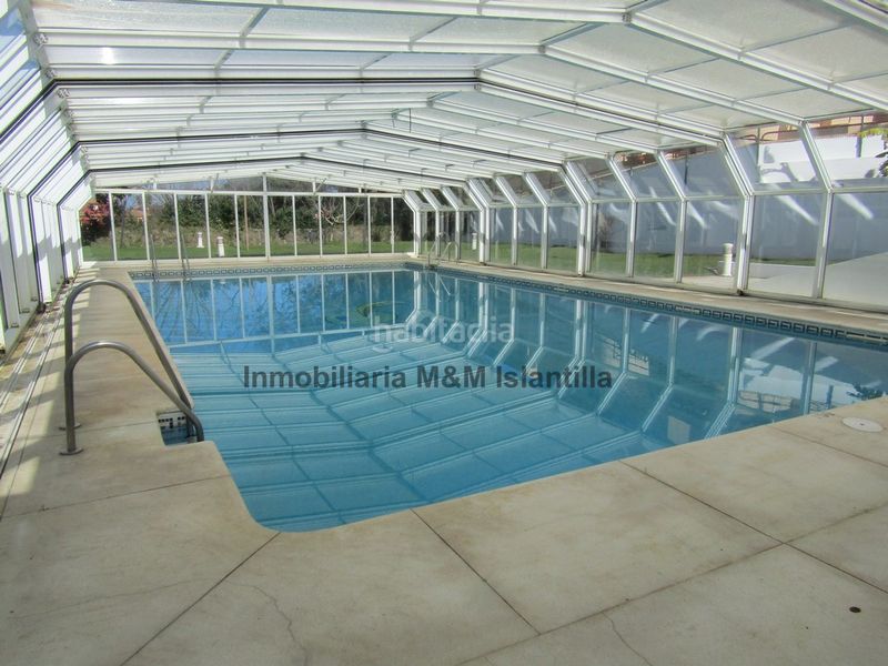 Foto 4c0f810d-aedb-4519-953a-cd174a8eda2f. Casa adossada amb aparcament piscina a Islantilla golf Islantilla