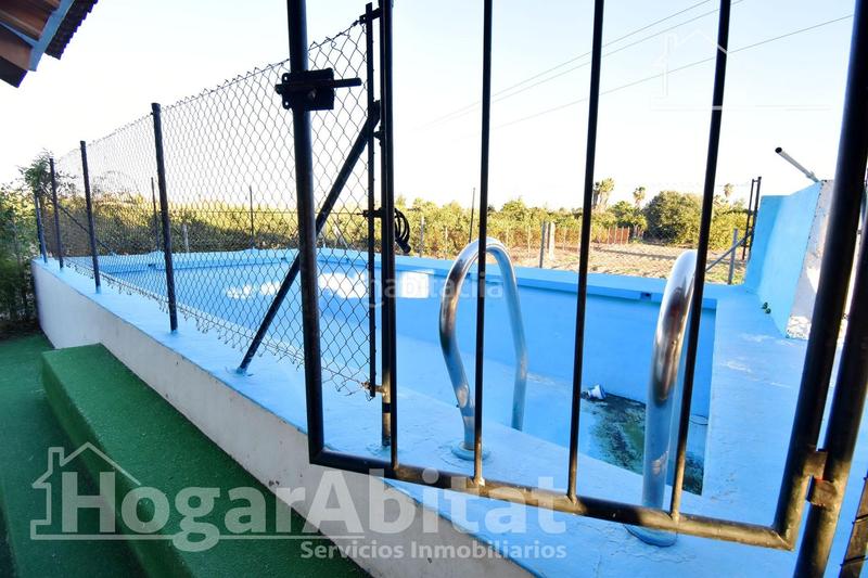 Foto fd230d73-fddc-40a6-aa55-086d606c965d. Chalet  con gran terreno, piscina, barbacoa y garaje en Gandia